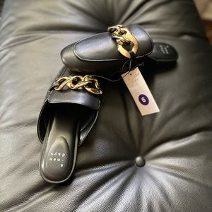Black loafers with gold chain